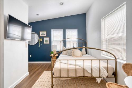 a bedroom with a bed in a room with blue walls at Stay Portland - Beach Vibes Getaway near Burnside & Laurelhurst! in Portland