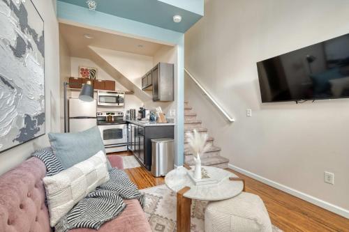 a living room with a couch and a kitchen at Chic Loft Retreat in the Heart of NW Portland in Portland