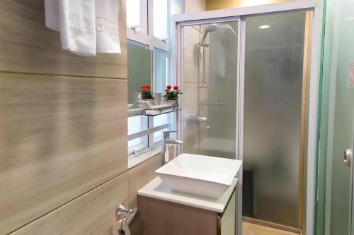 a bathroom with a sink and a shower at Metroplace Boutique in Hong Kong