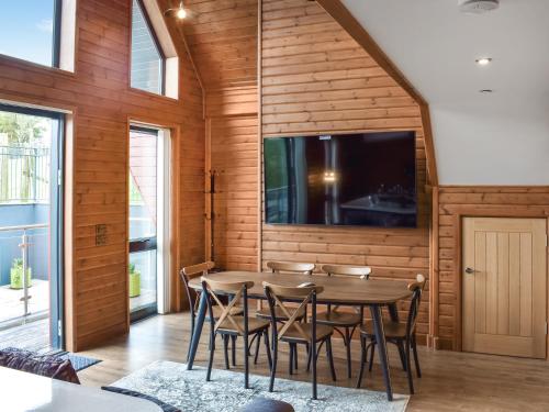 a dining room with a table and chairs and a flat screen tv at Briallen - Primrose - Ukc7075 in Mydroilin