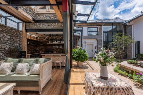 an outdoor patio with a couch and a bar at Dali GuGu Hotel in Dali Ancient Town