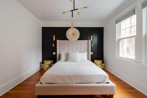 a bedroom with a white bed and a black wall at Stay Portland - Elegant World's Fair 4BR Home 97 WalkScore in Portland