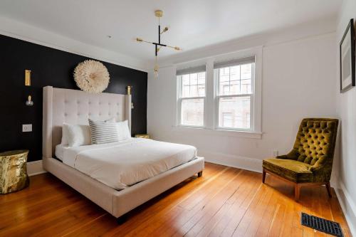 a bedroom with a white bed and a chair at Stay Portland - Elegant World's Fair 4BR Home 97 WalkScore in Portland