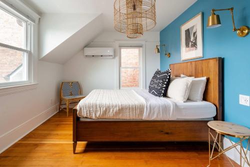a bedroom with a bed and a blue wall at Stay Portland - 7BR 1906 Carl & Margaret Hoeber World's Fair House in Portland