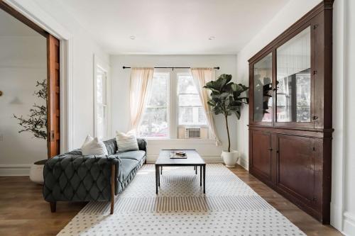 a living room with a couch and a table at Stay Portland - The Étoile Suite - Nob Architecture & Boutiques in Portland