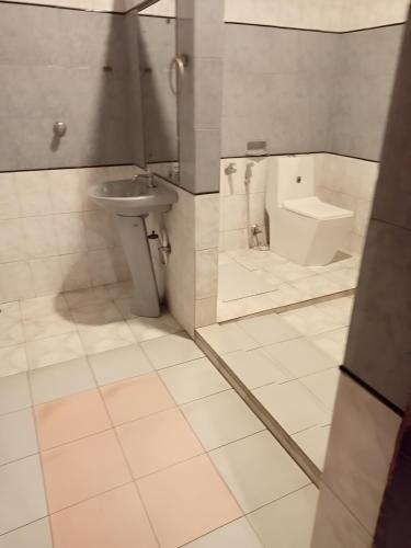 a bathroom with a sink and a toilet at Coorg Mystere Luxury Home Stay in Madikeri