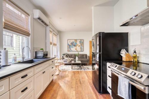 a kitchen with a stainless steel refrigerator and a stove at Stay Portland - The Etourdissante Suite - Forest Park & Local Eats in Portland