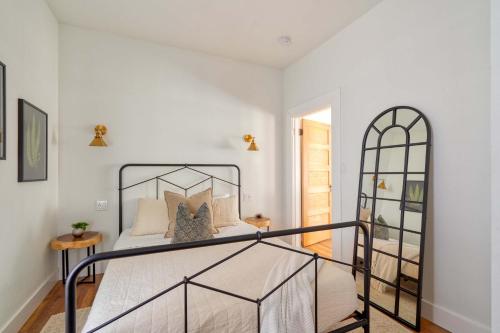 a bedroom with a bed with a wrought iron bed frame at Stay Portland - The Etourdissante Suite - Forest Park & Local Eats in Portland