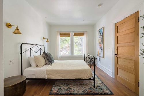 a bedroom with a bed and a window at Stay Portland - The Câlin Suite - Posh Local Boutiques & Eateries in Portland