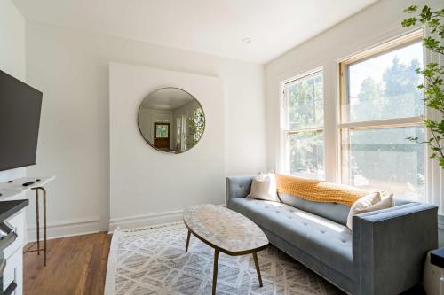 a living room with a couch and a mirror at Stay Portland - NW 23rd - 1BR - Best Location - Historic Beauty in Portland
