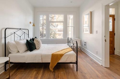 a bedroom with a bed with white sheets and pillows at Stay Portland - 1BR - Walk to Coffee, Brews & NW 23rd Shops in Portland