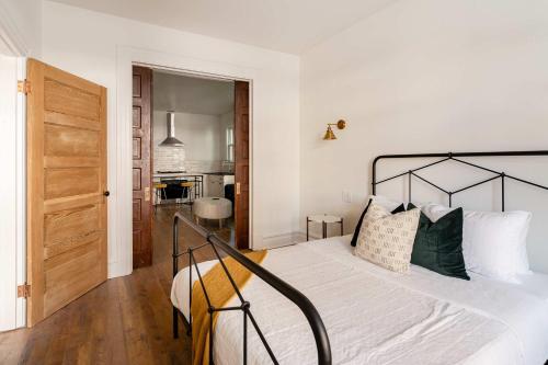a bedroom with a large white bed with green pillows at Stay Portland - 1BR - Walk to Coffee, Brews & NW 23rd Shops in Portland
