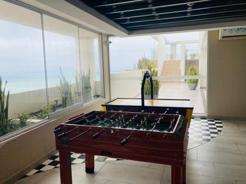 a room with a pool table on a balcony at San Miguel Apartment Ocean Magic in Lima