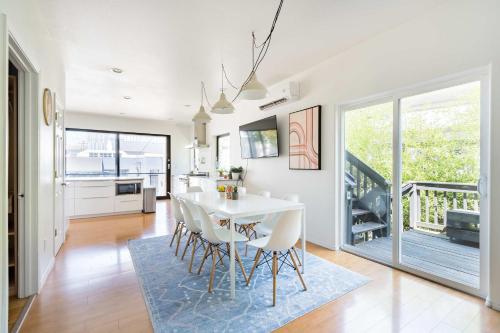 a kitchen and dining room with a white table and chairs at Luxurious Portland 3BR in the Pearl District in Portland