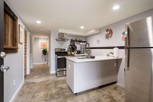 a kitchen with a sink and a refrigerator at Stay Portland - Lovely location, 4 BR Pearl apt, Sleeps 8 in Portland