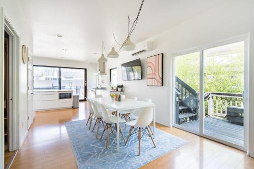 a kitchen and dining room with a white table and chairs at Stay Portland - Unique 8 BR Private Home in Pearl District in Portland