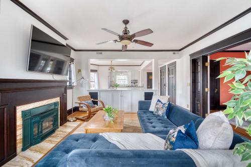 a living room with blue couches and a fireplace at 1910 Historic Jessie Morehead House in Portland