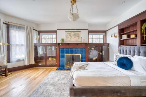a bedroom with a large bed and a fireplace at 1910 Historic Jessie Morehead House in Portland
