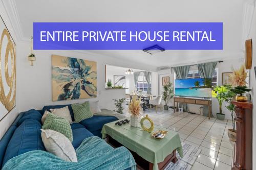a living room with a blue couch and a table at Entire Private Home with 4 Bedrooms 2 Bathrooms, Garage & Gated Yard, Near San Diego Gaslamp, Beach, Available Now in National City
