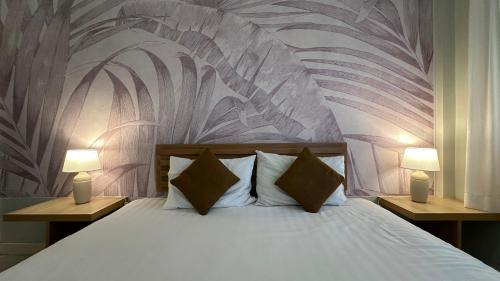 um quarto com uma cama com 2 candeeiros nas mesas em Spice & Sea Resort em Kata Beach