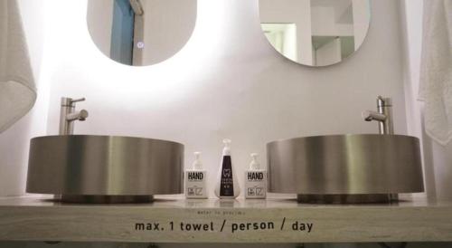 a bathroom with two sinks and a mirror at SLEEEP HKG Causeway Bay in Hong Kong