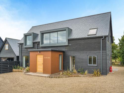 a house with a grey roof and a garage at Lime Tree House - Uk49477 in Bulmer