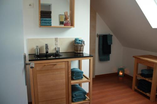 a bathroom with a sink and a counter with towels at La demeure d'Ervée in Isigny-sur-Mer