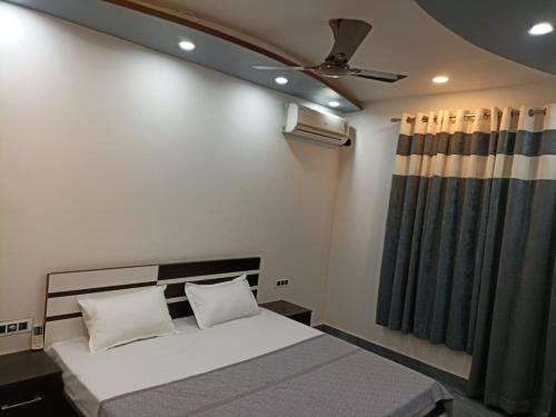 a bedroom with a bed and a ceiling fan at The Royal Scout Homestay in Changar Talai
