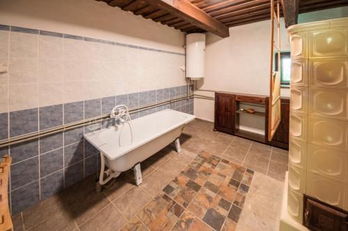 a bathroom with a white bath tub in a room at Country House Fort Lacnov in Lipovce