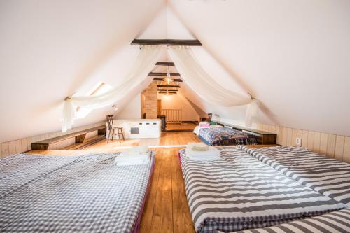 a room with three beds in a attic at Country House Fort Lacnov in Lipovce