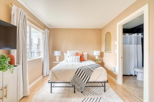a bedroom with a bed and a bathroom at Stay Portland - John's Landing Haven - Studio Near OHSU in Marquam Hill