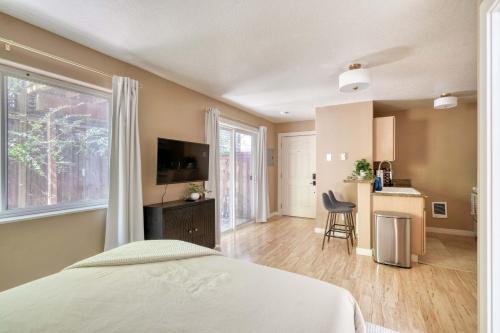 a bedroom with a bed and a large window at Stay Portland - Peaceful Johns Landing Studio - Near OHSU in Marquam Hill