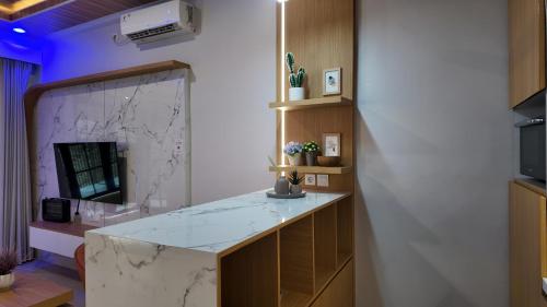 a kitchen with a marble counter and a mirror at Lightstar Modern Villa Mandalika in Kuta Lombok