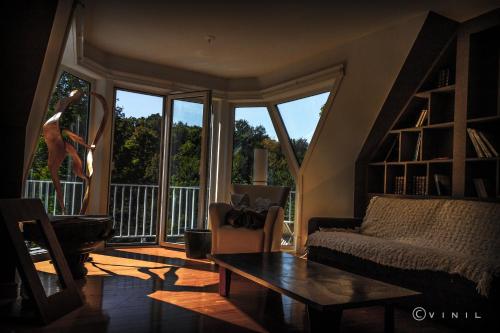 a living room with a couch and a table at Villa Nao in Roxton Falls
