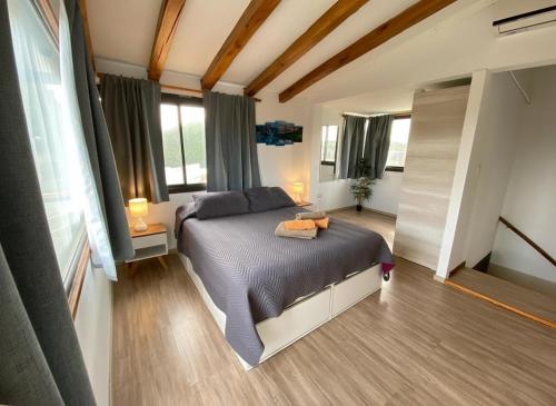 a bedroom with a bed and a large window at Villa Bella vista 2024 in San Rafael