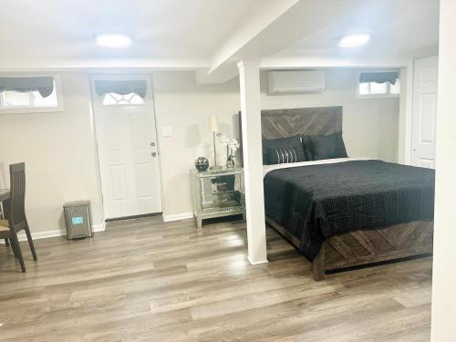 a bedroom with a bed and a table and chairs at Belmont Lux Escape - Walkable Studio 19 Miles to Manhattan in Elmont