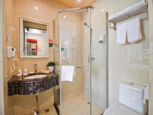 a bathroom with a shower and a sink and a toilet at GreenTree Inn HeFei LongChuan Road South Hefei Railway Station Business Hotel in Hefei
