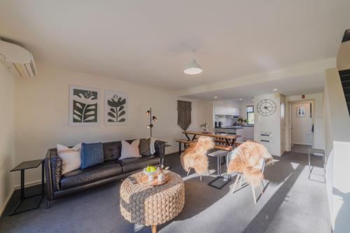 a living room with a couch and a table at Elegant 3-Storey Townhouse with Garage Parking by Latimer Sq in Christchurch