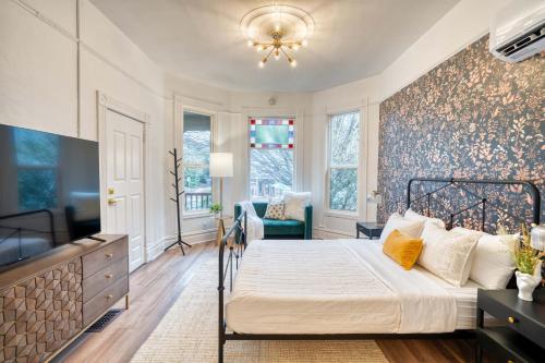 a bedroom with a bed and a tv in a room at Stay Portland - Historic Queen Anne Vernacular - 95 WalkScore in Portland