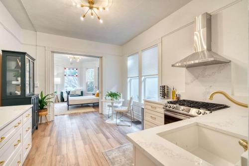 a kitchen with white cabinets and a stove top oven at Stay Portland - Historic Queen Anne Vernacular - 95 WalkScore in Portland