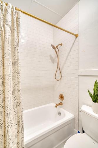 a white bathroom with a tub and a toilet at Stay Portland - Historic Queen Anne Vernacular - 95 WalkScore in Portland