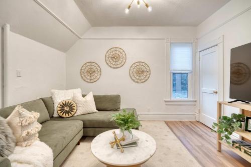 a living room with a couch and a table at Stay Portland - Historic Queen Anne Vernacular - 95 WalkScore in Portland