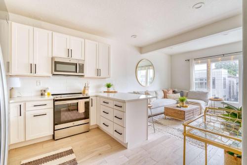 a kitchen with white cabinets and a living room at Stay Portland - Perfect Portland Farmhouse Loft - Breweries & Bars in Portland