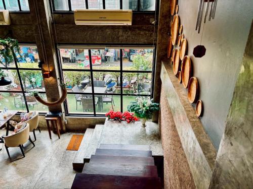 a room with a staircase and a large window at Sukhum Victorymonument-Ari in Bangkok