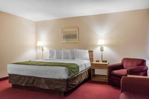 a hotel room with a bed and a chair at Quality Inn Arena in Wilkes-Barre