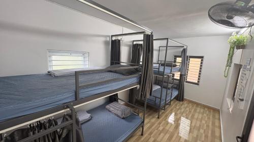 two bunk beds in a room with a hallway at Mikey House Ha Giang - Tour Operator & Homestay in Làng Xa