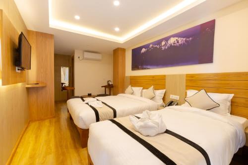 Postel nebo postele na pokoji v ubytování Atithi Hotel & Apartment