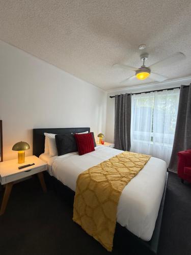 a hotel room with a large bed and a window at Absolute Beachfront Apartment, Kawana Beach Escape in Buddina