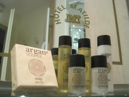 a group of four bottles of skin care products on a shelf at Hotel Matilde in Marina di Massa