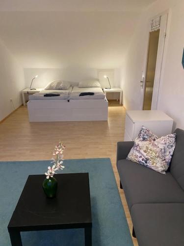 a living room with a couch and a bed at Oberdorf in Konstanz
